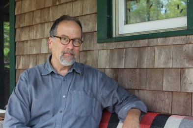 Cartoonist Paul Karasik on his front porch in West Tisbury. His Ag Fair poster design won the annual contest.